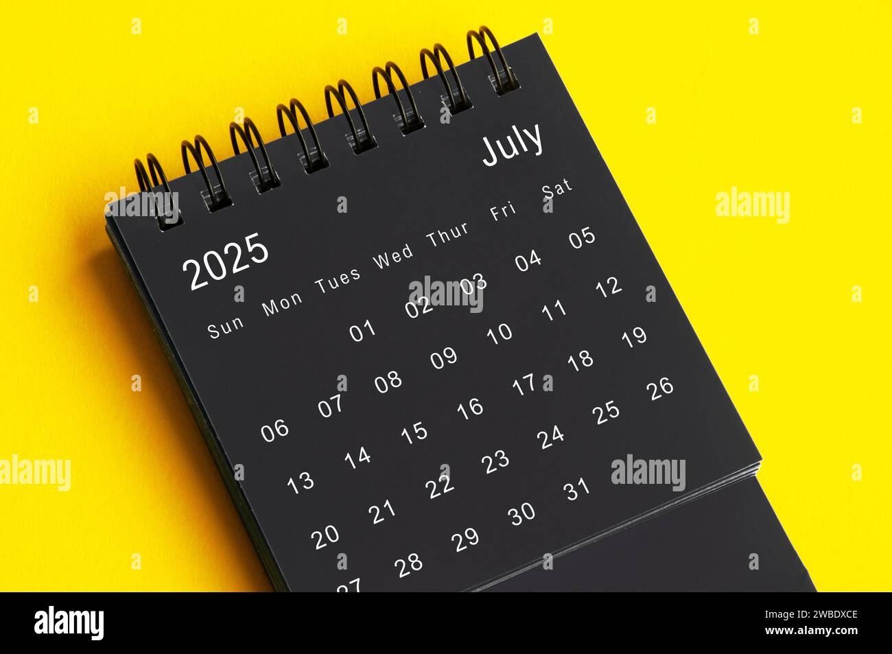July 2025 Black And White Desk Calendar On Yellow Cover Background Calendar Concept Stock Photo Alamy